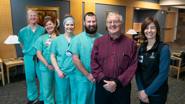 Ron Wastier standing next to the Cath Lab medical team.