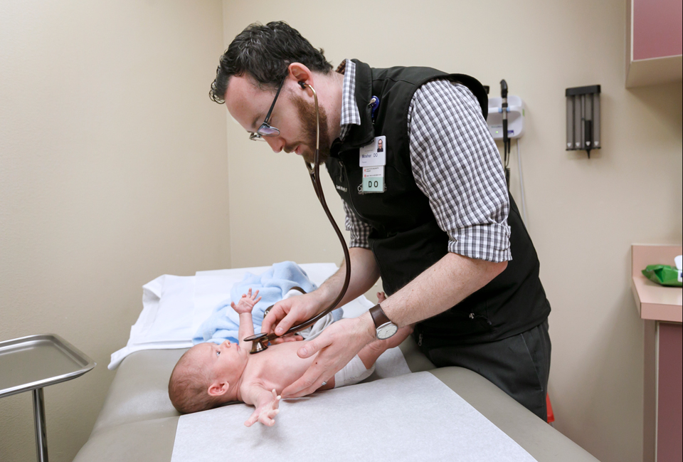 Doctor examining a baby.