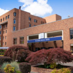 Exterior of hospital entrance with sign
