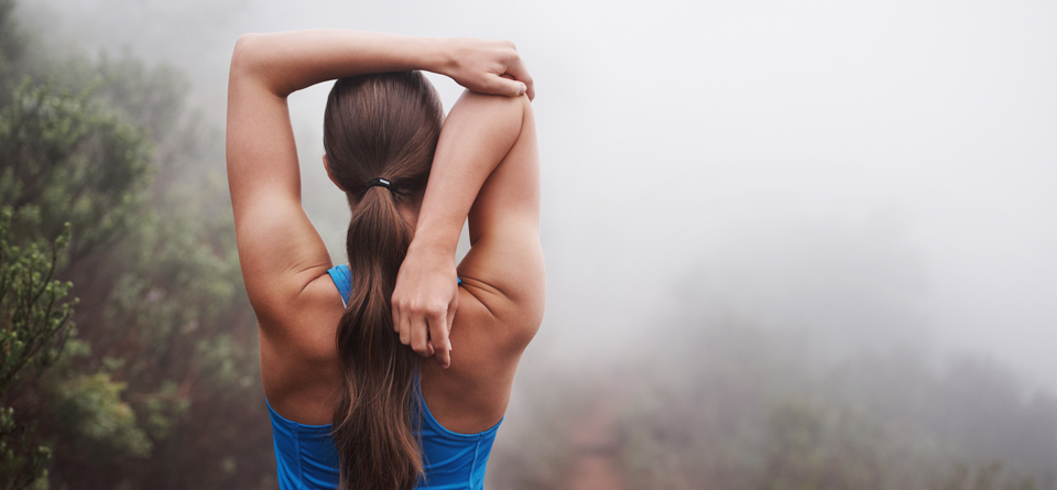 Athletic woman stretching arms