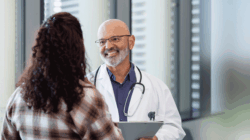 Doctor smiling at a patient.