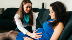 Midwife examines pregnant woman.