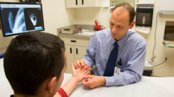 Dr. Langer examines a patient's hand