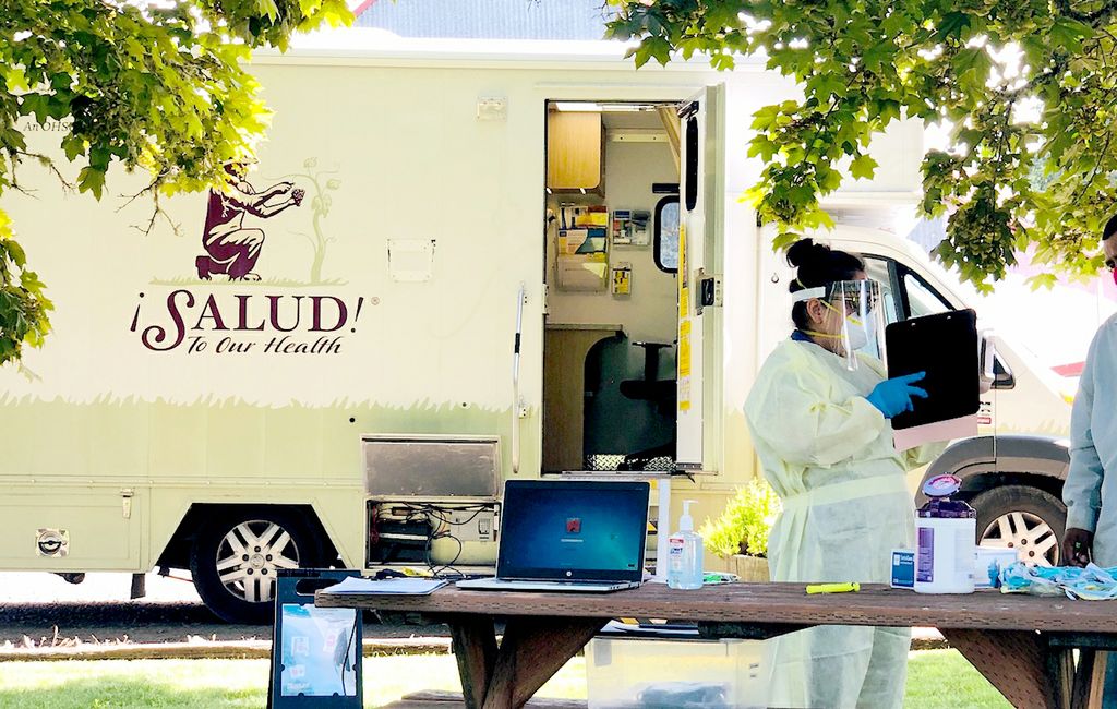 Salud! van at vineyard with a person wearing PPE