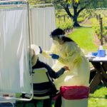 Salud staff screening seasonal worker in a vineyard.
